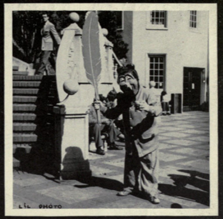 Archival scan: Oski performing beside another costumed figure outdoors. Photo credit: Photographer/artist uncredited in supplied scan.