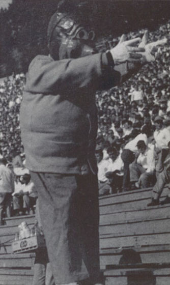 Archival scan: Oski leading a yell in the stands. Photo credit: Photographer/artist uncredited in supplied scan.