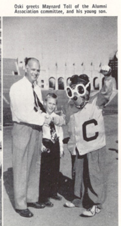 Archival scan: Oski with visitors in front of a building. Photo credit: Photographer/artist uncredited in supplied scan.