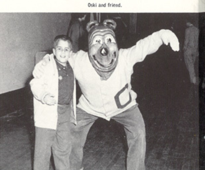Archival scan: Oski posing with a young fan. Photo credit: Photographer/artist uncredited in supplied scan.