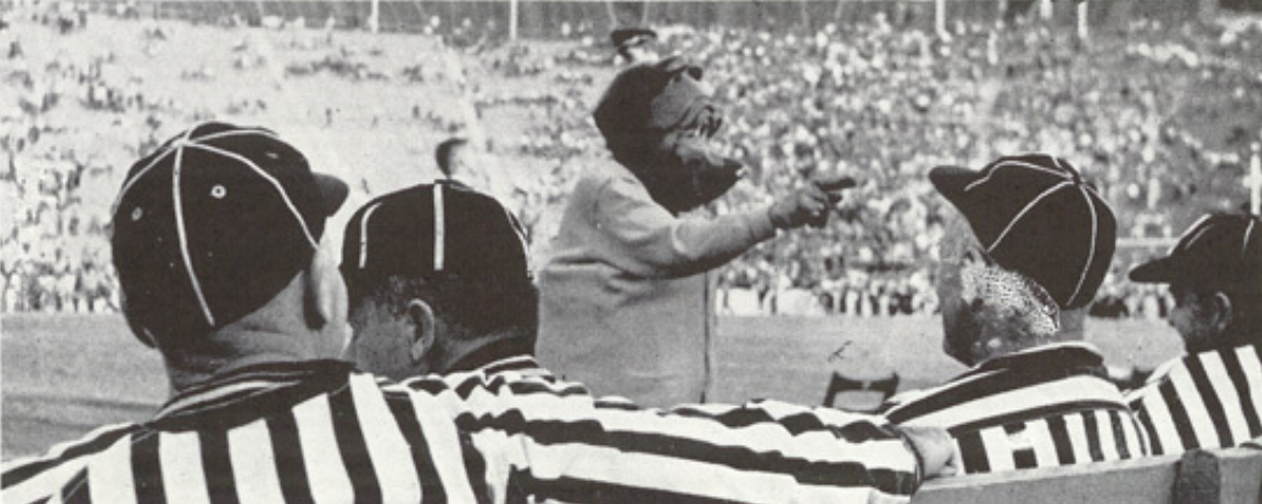 Archival scan: Oski gesturing between two football officials. Photo credit: Photographer/artist uncredited in supplied scan.