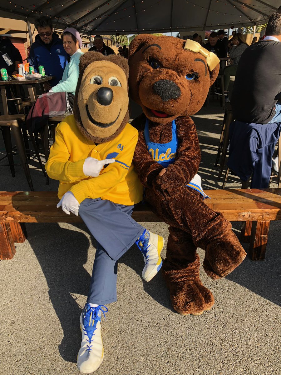 Oski and Josie Bruin sitting closely together on a bench. Posted by @Oski. Photo credit: Posted by @Oski; photographer uncredited.