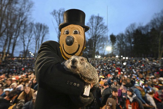 Edited image of Oski in a top hat holding a groundhog before a crowd. Photo credit: Original creator unverified; X media supplied by @calwokebot.